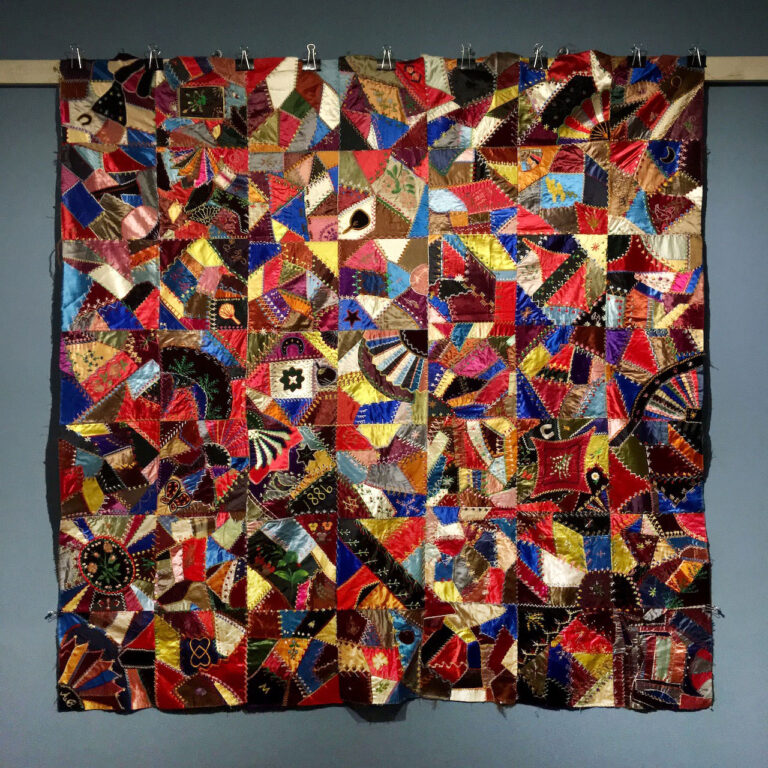 Brightly colored silk crazy quilt top with embroidered and painted motifs