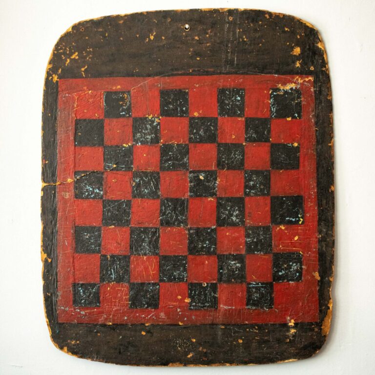 Large red and black painted folk art checkerboard on masonite, 1930s