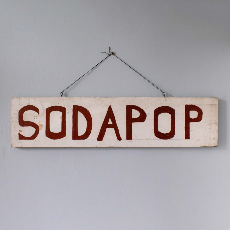 Hand-painted Sodapop sign in glossy red lettering on white