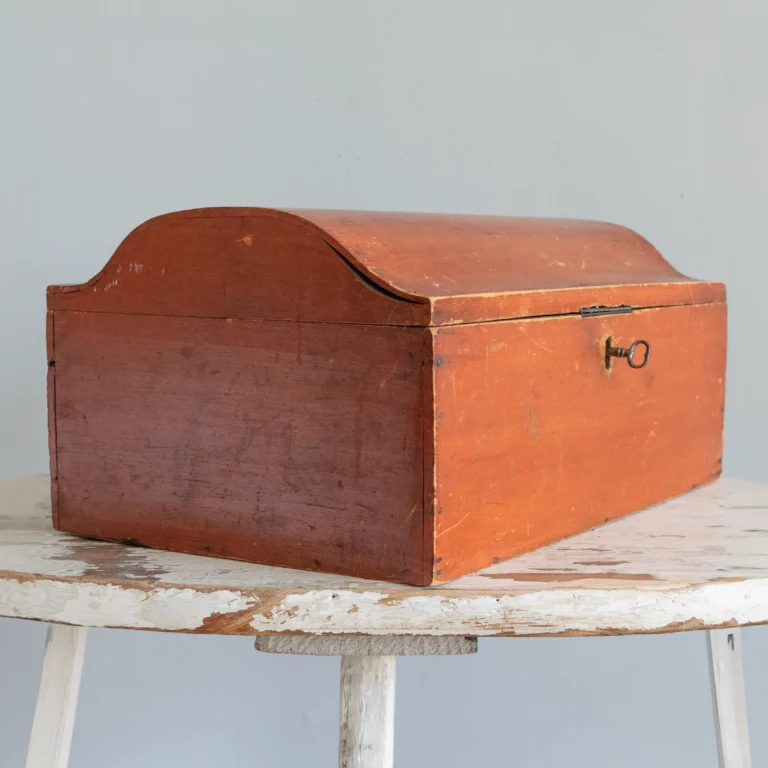 Antique painted box in salmon color with shaped top