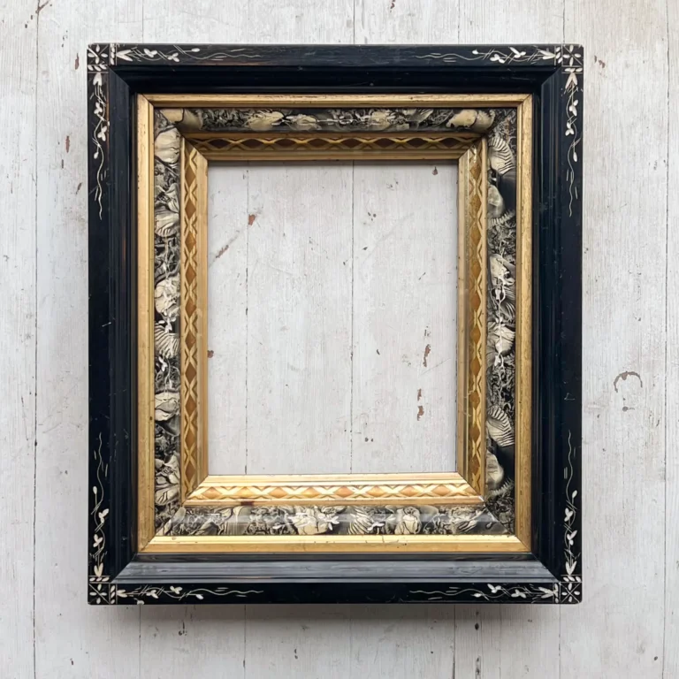 Black Eastlake picture frame with incised florals and faux tortoiseshell panel