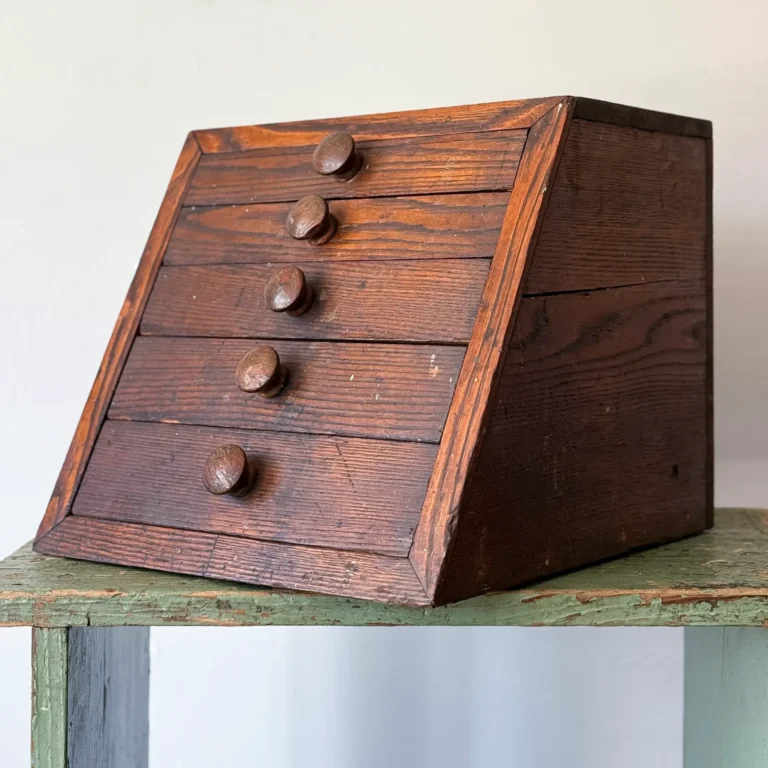 Antique oak tabletop chest of drawers with sloped front and five drawers